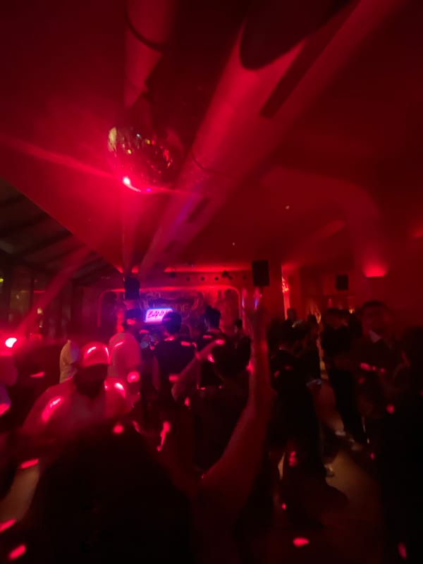 Red-lit Mumbai club night with DJ set and themed decor
