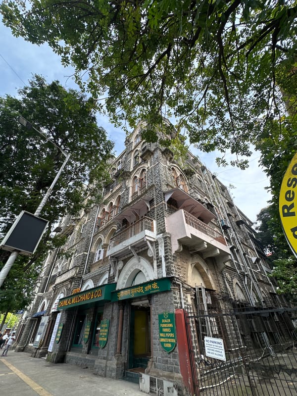 Historic stone commercial building with Chunilal Mulchand & Co. signage, Mumbai
