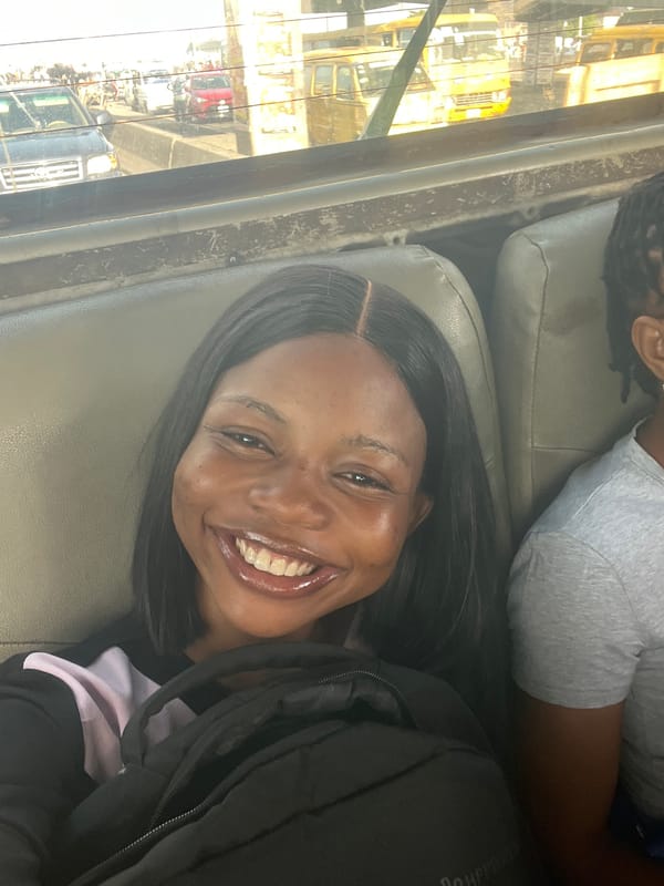 Woman photographed smiling in vehicle, Satellite Town Nigeria