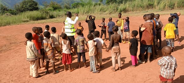 Adult leads children's activities in DRC villages