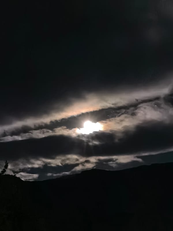 Moon partially obscured by layered clouds observed in Bulgaria