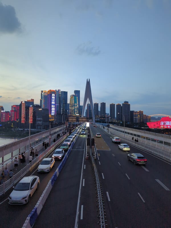 Chongqing's Hongyadong Bridge glows red at dusk