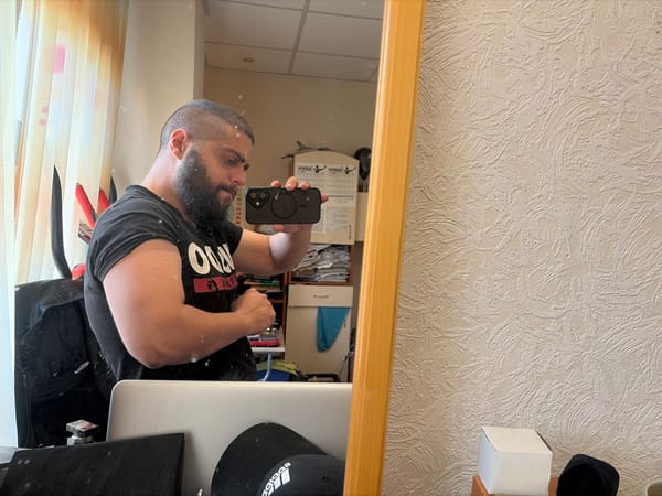 Bearded man documented in mirror selfie and wall portrait