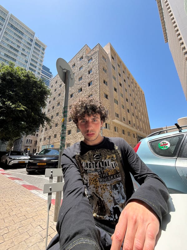 Young man photographed amid modern architecture in Tel Aviv