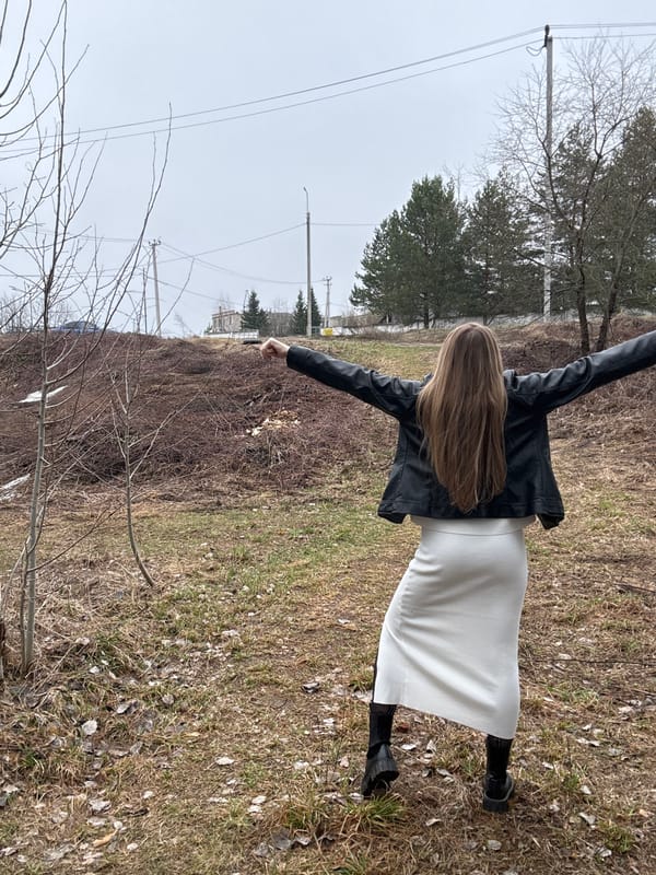 Woman photographed in field poses near Chaikovsky, Russia