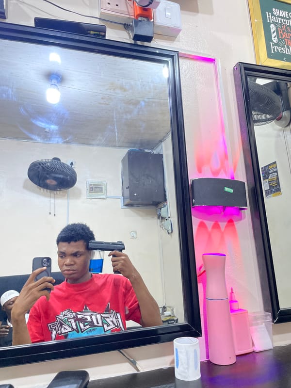 Evening barbershop activity documented in Ado, Nigeria