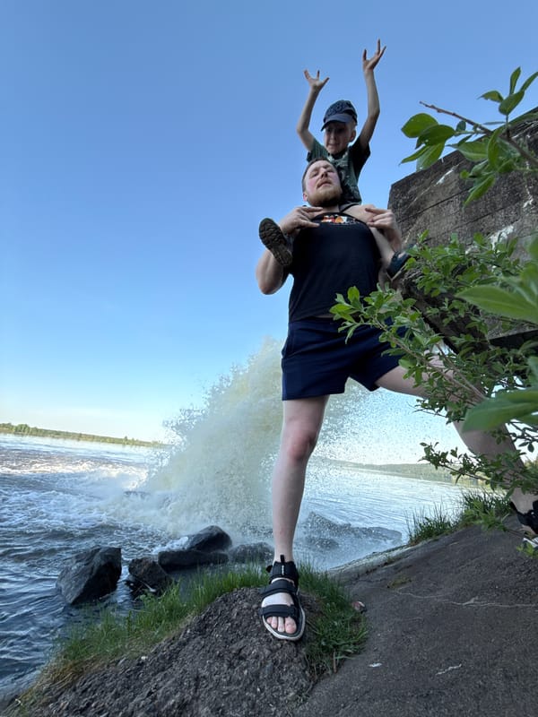 Father and child enjoy piggyback ride near Russian waterfall