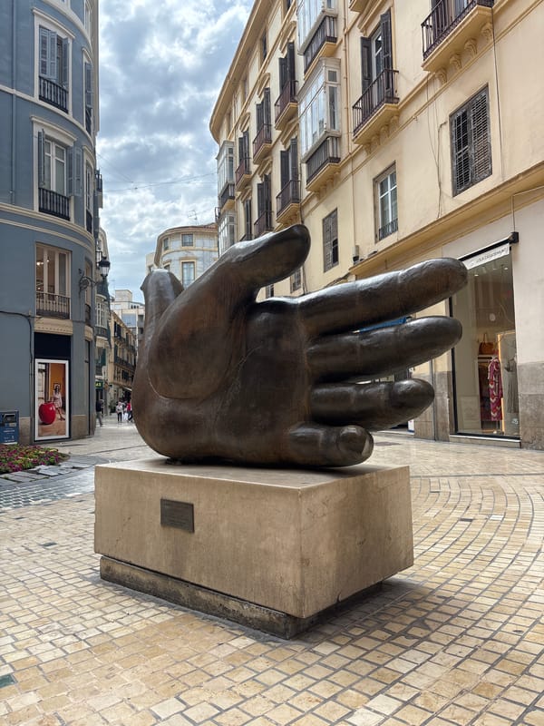 Bronze hand sculpture spotted on Málaga pedestrian street