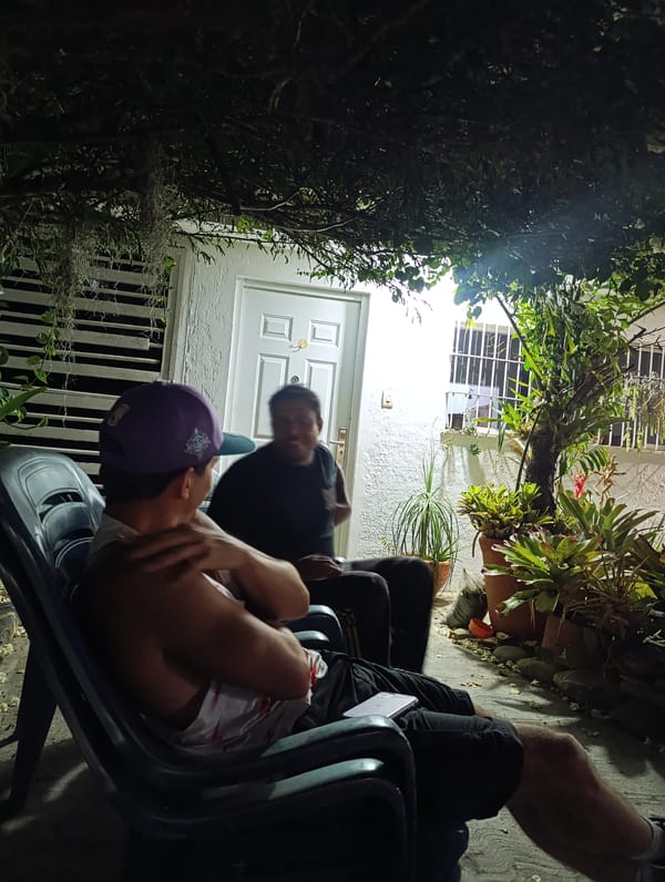 Two men photographed in nighttime conversation in Tinaquillo, Venezuela