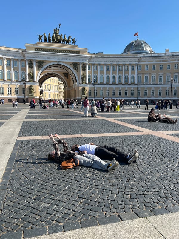 Two people observed on historic Saint Petersburg plaza