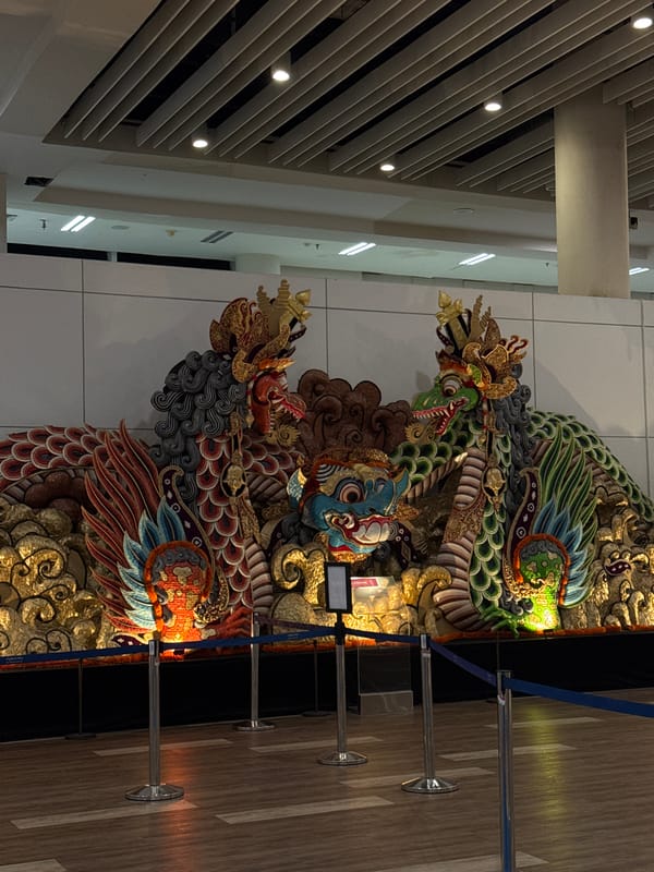 Father and daughter visit decorated public space with dragon artwork