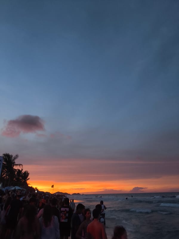 Evening crowds gather at Playa Parguito beach during sunset
