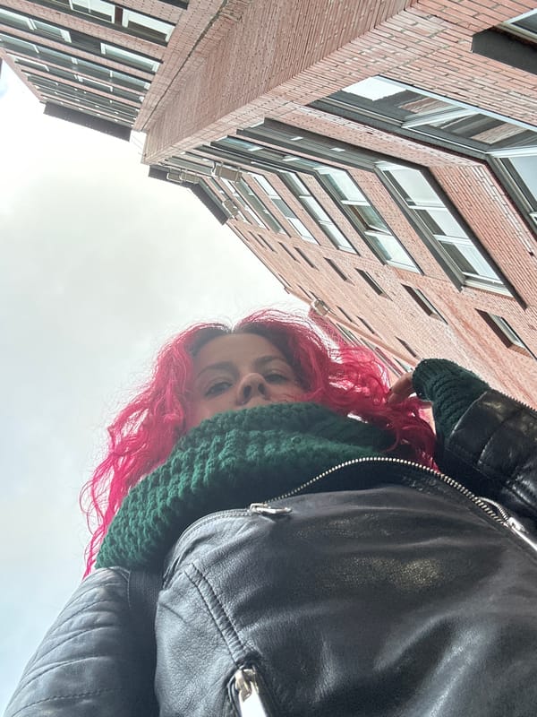 Pink-haired person photographed amid spring scenery in Novosibirsk