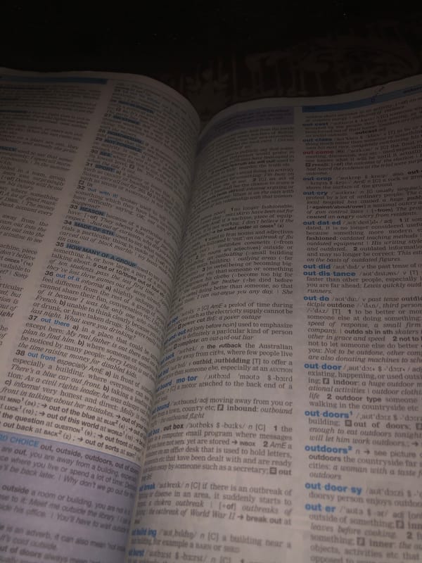 Flipping through a dictionary by lamplight in Jalingo
