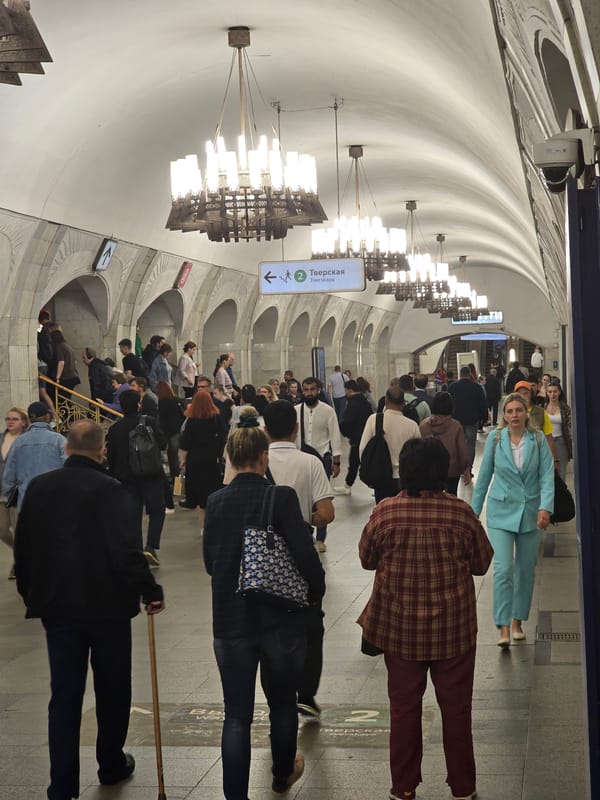 Inside an ornate, chandelier-lit metro station