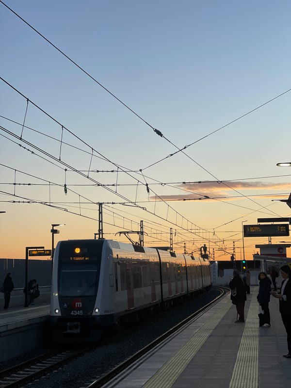 Metro Valencia train arrives at Paiporta station during dawn