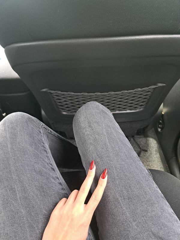 Person with red nails photographed inside car in Bulgaria