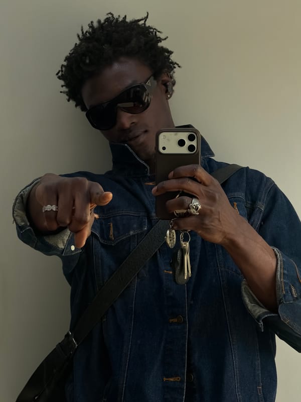 Person takes mirror selfie in denim jacket, London