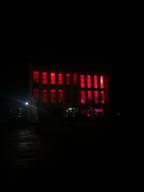 Building windows glow red-purple in nighttime Yerevan