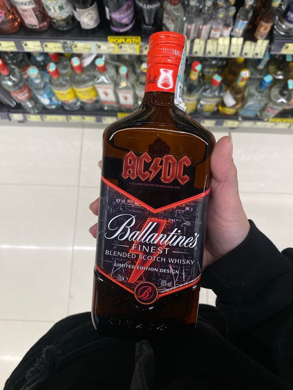 Person takes selfie with whisky bottle in Montenegro store