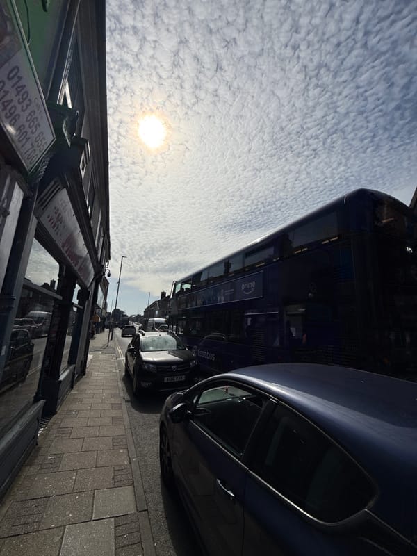 Double-decker buses spotted on Gorleston-on-Sea street under cloudy skies