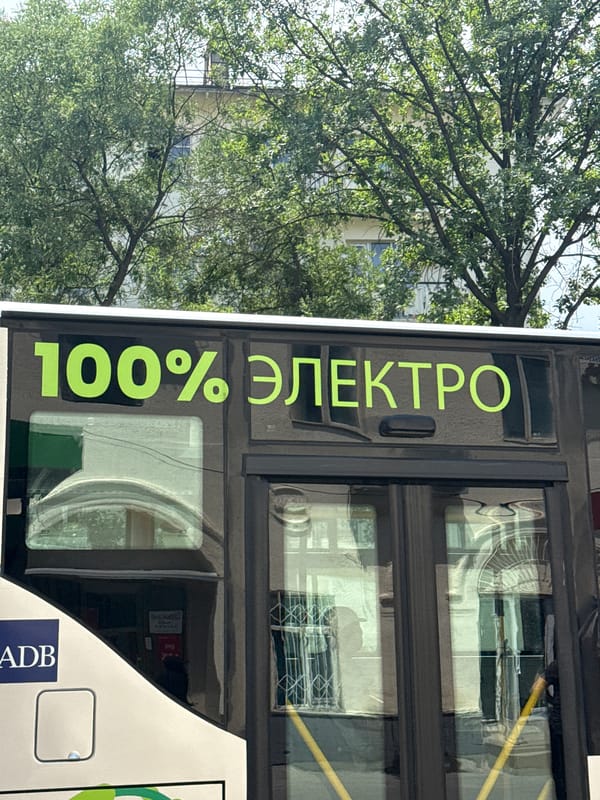 Electric buses and street life near a Central Asian market