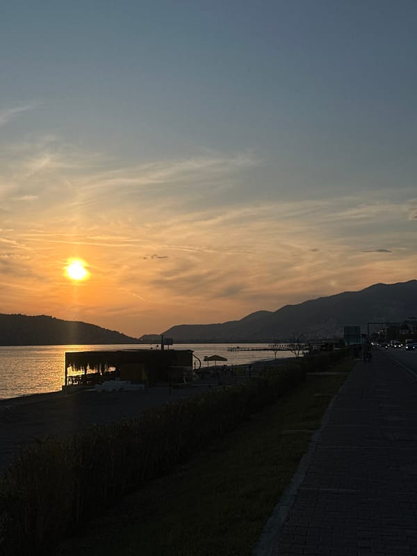 Mediterranean sunset and beach activity observed in Alanya, Turkey