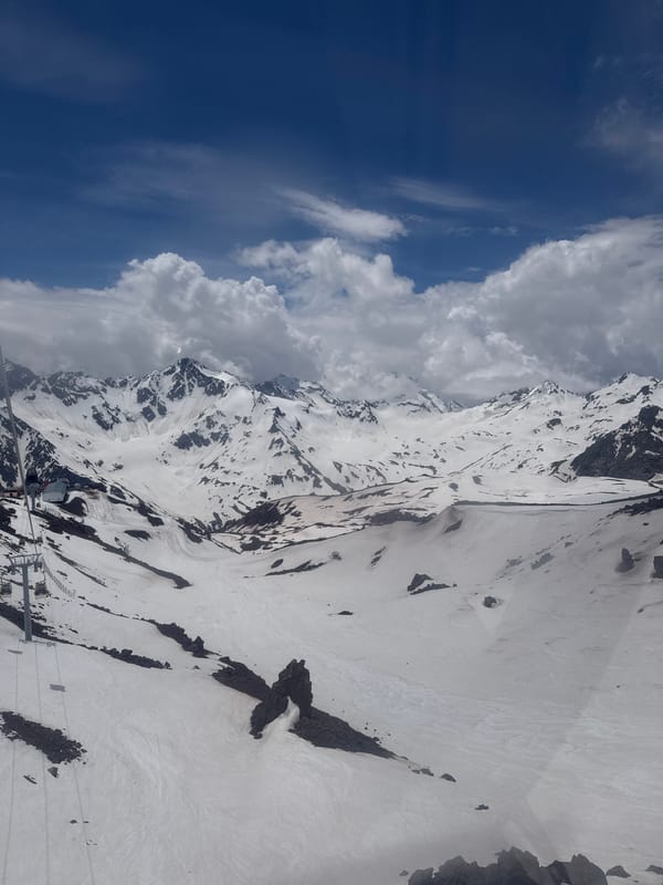 Snow-covered peaks and rocky ridges above Terskol, Russia