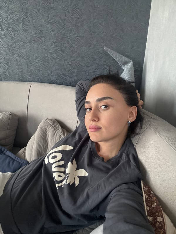 Woman rests on couch in Tbilisi home