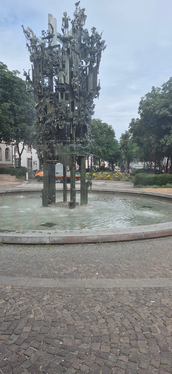 Intricate bronze fountain spraying in central Mainz