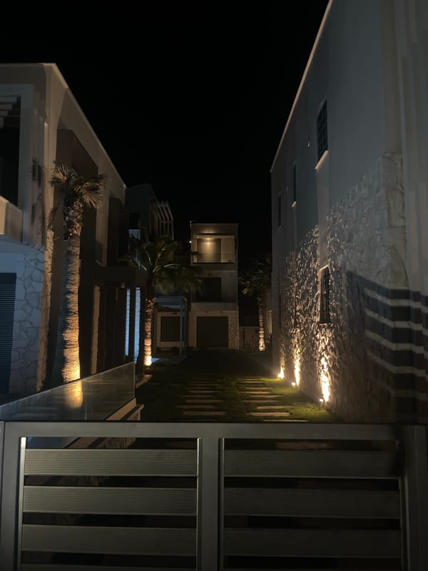 Modern beachside buildings documented at night in Ofrynio, Greece