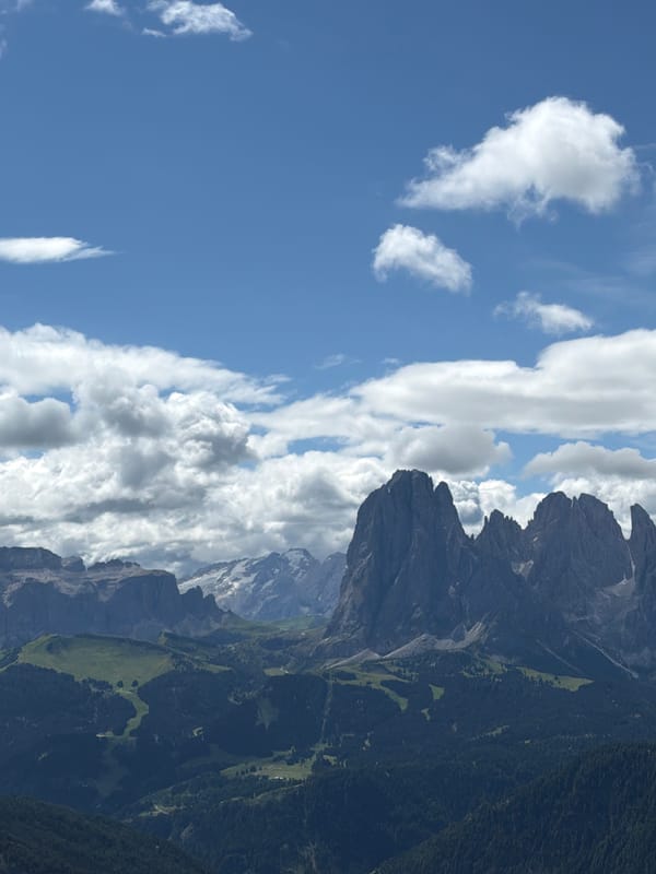 Stone cairns and forested peaks above Ortisei, Dolomites