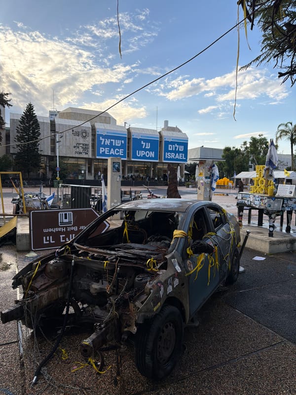 Damaged vehicle and symbolic displays documented at Tel Aviv squares