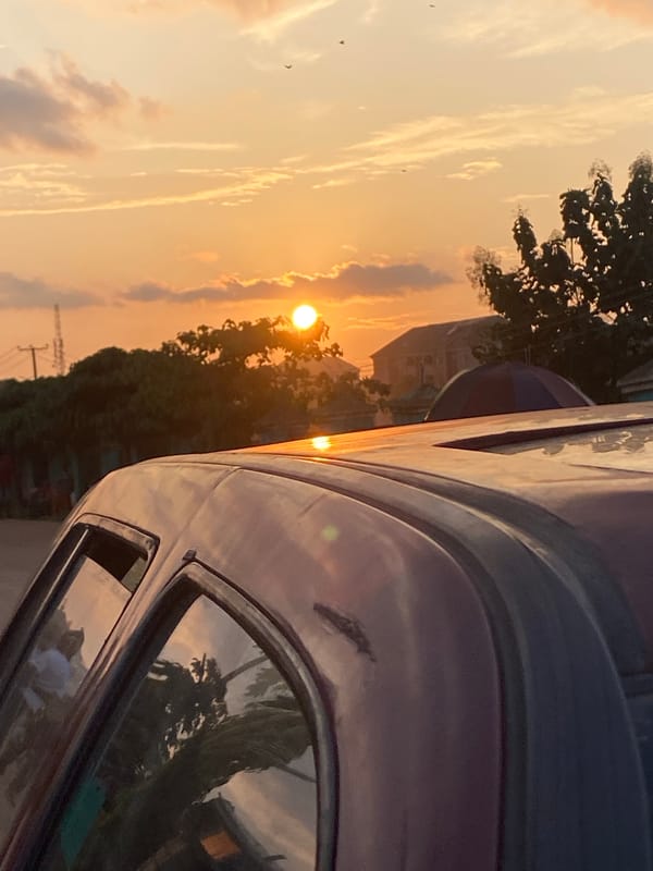 Orange sunset through clouds over Abakaliki, Nigeria