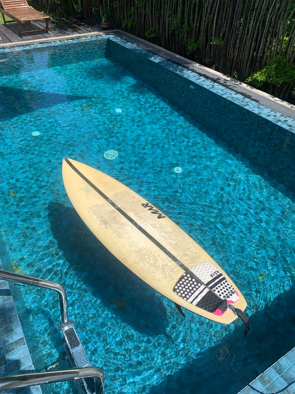Surfboard floats in swimming pool in Kabalana, Sri Lanka