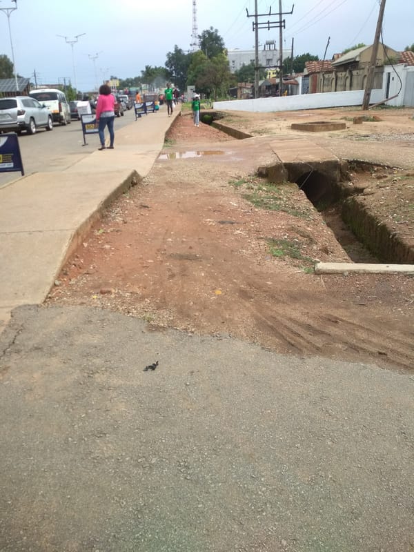 Daily life unfolds on Jos streets under cloudy skies