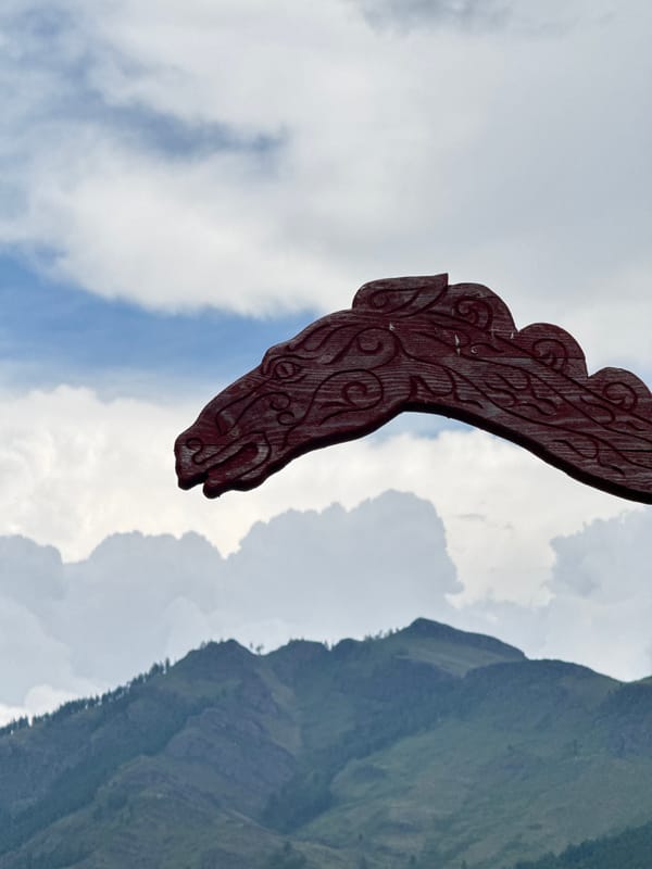 Rural Siberian homestead visit with folk carvings and mountain scenery