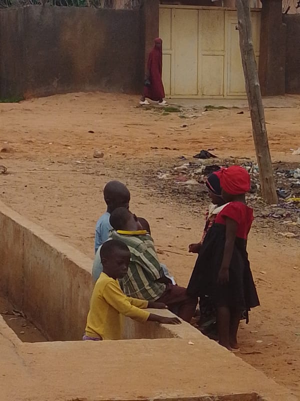 Daily street life across a dusty urban neighborhood