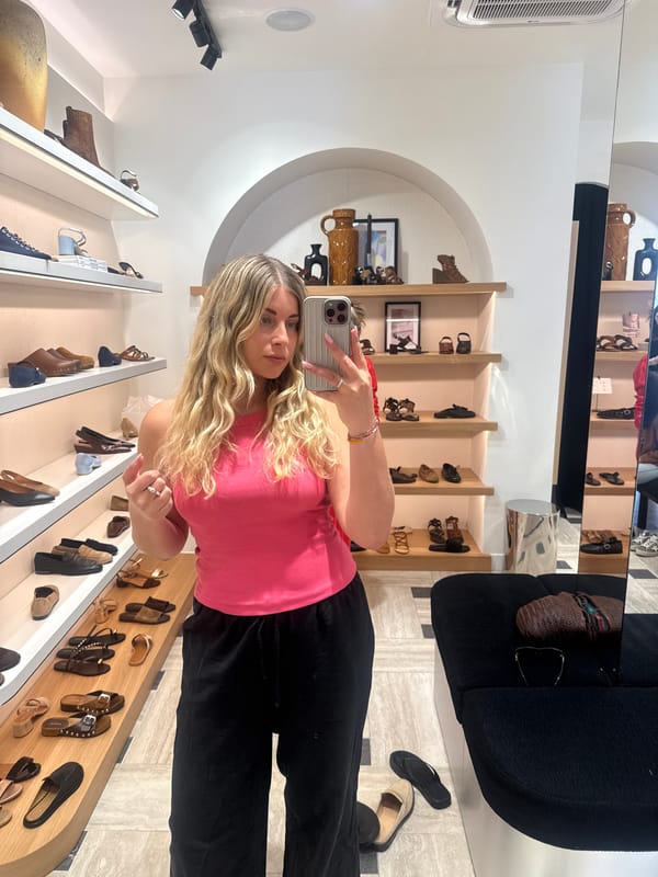 Woman takes selfie in Paris shoe store