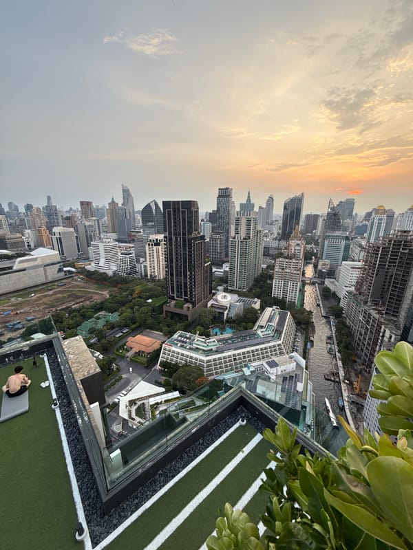 Bangkok rooftop yoga session captured amid dusk cityscape views
