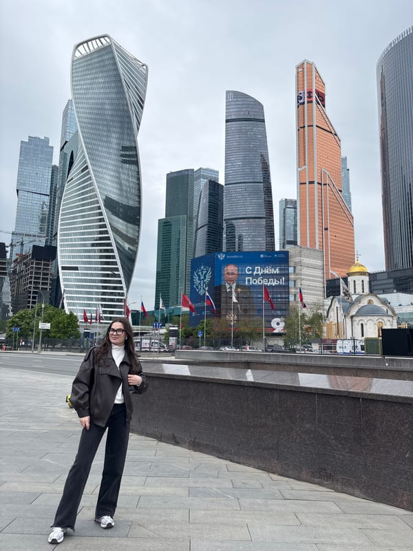 Woman photographs selfies at Moscow's business district skyline