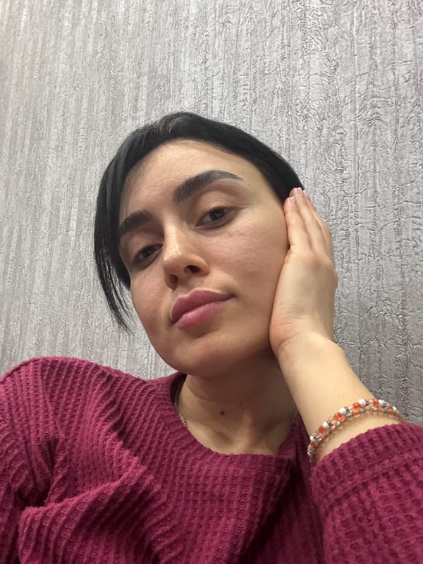 Woman takes indoor selfies in Tbilisi home setting