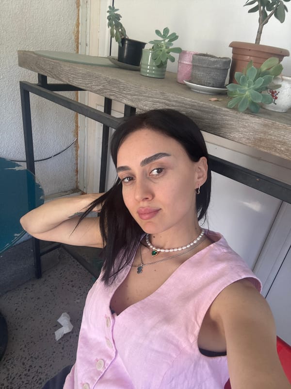 Woman poses for photos on Tbilisi balcony