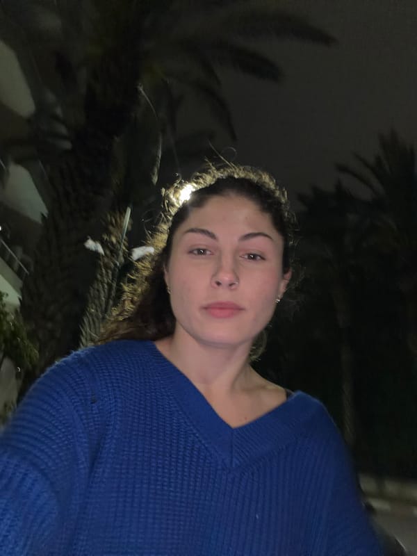 Woman photographed in blue sweater at two Kiryat Bialik locations