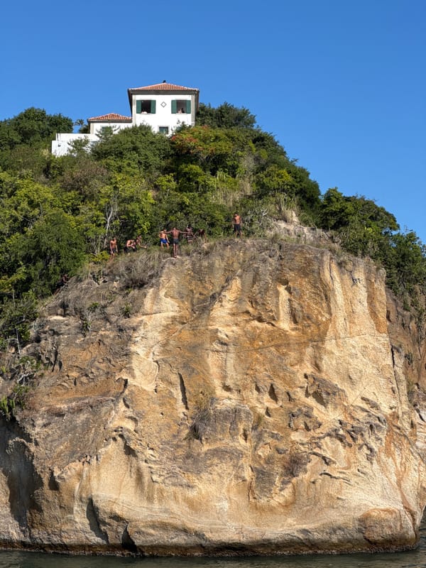 Cliff jumping off Niterói's rocky coastline