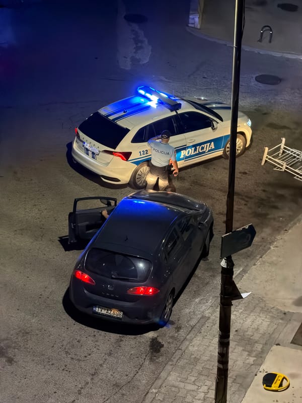 Police presence with lights active in nighttime Budva