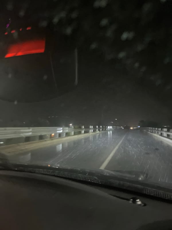 Driver navigates rainy night streets in Blagoevgrad, Bulgaria