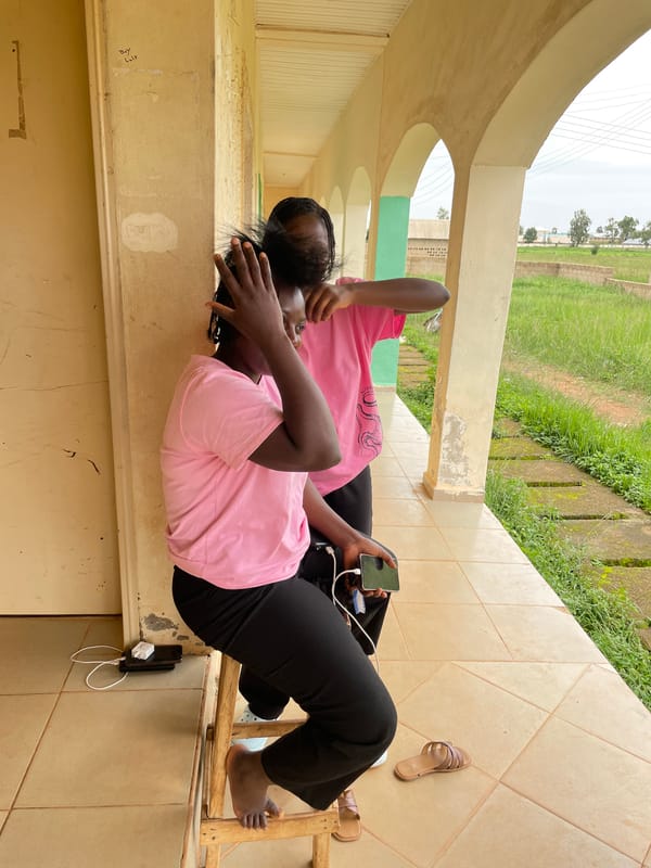 Outdoor hair braiding session in Durimi, Nigeria
