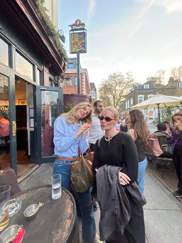 Woman seated at outdoor table during London gathering