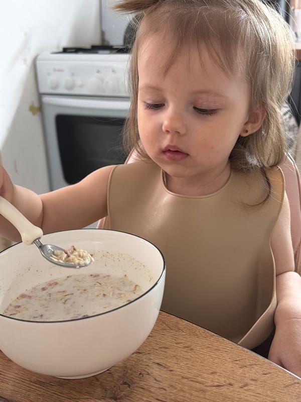 Child enjoys breakfast cereal in Reshetnikovo, Russia